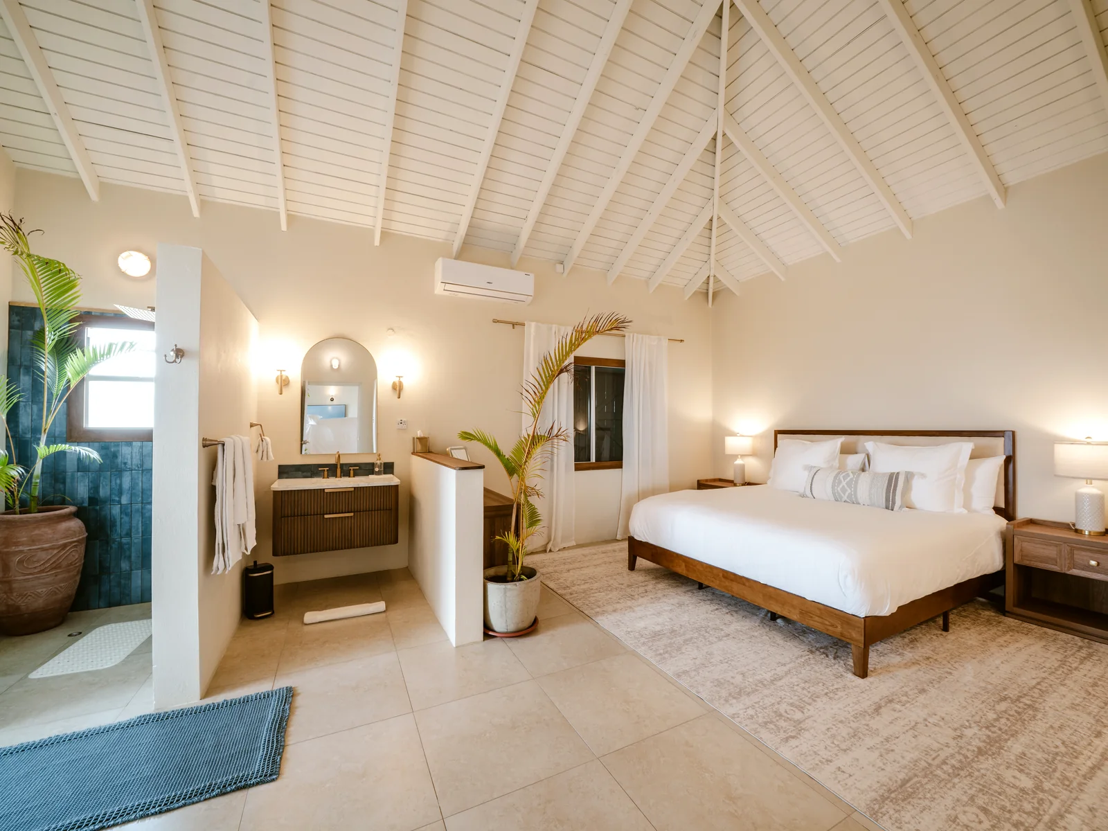 Air-conditioned king bedroom at Mer & Sel Villa with ensuite bathroom area