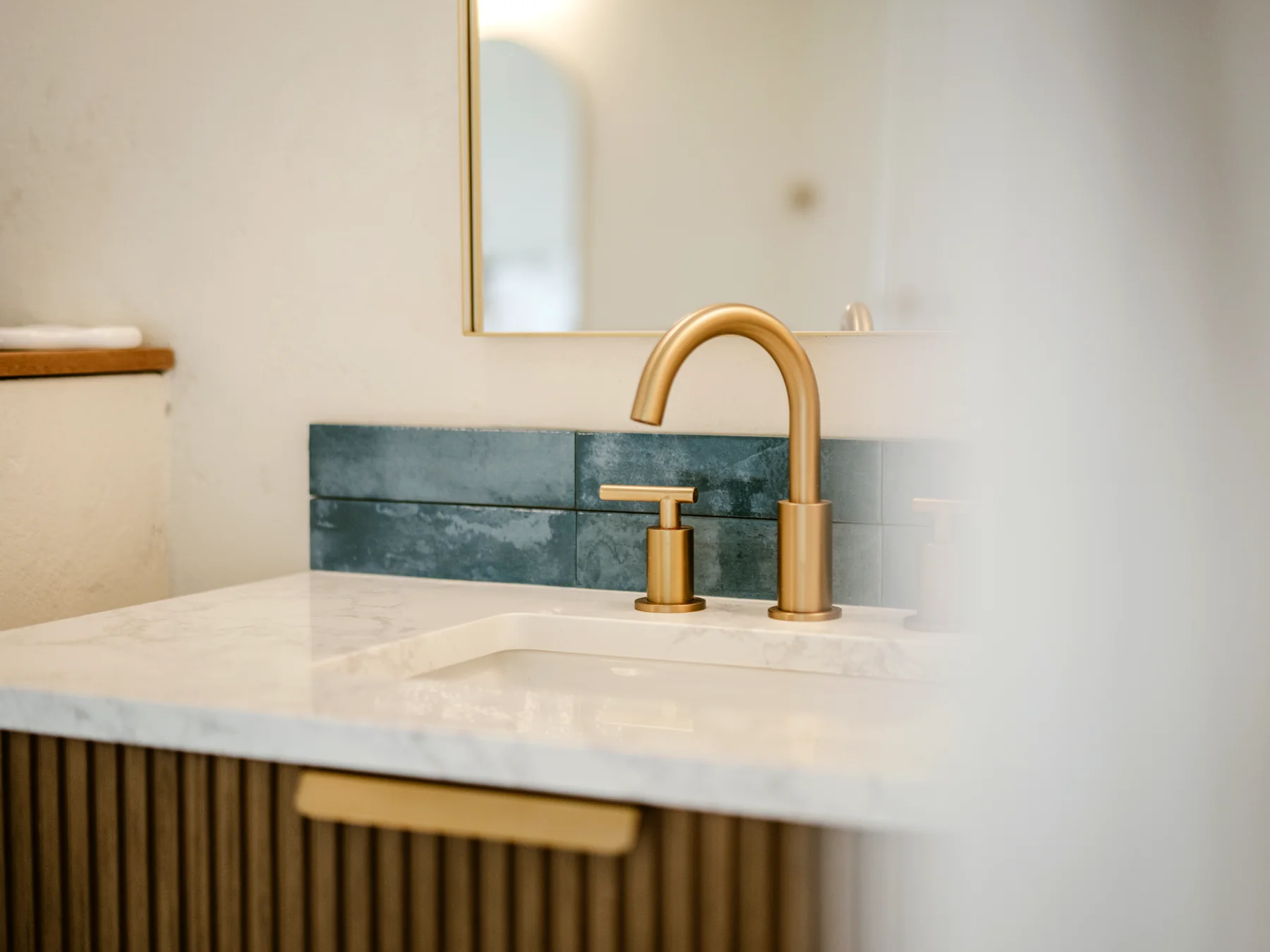 Bathroom vanity detail with brass fixtures at Mer & Sel Villa