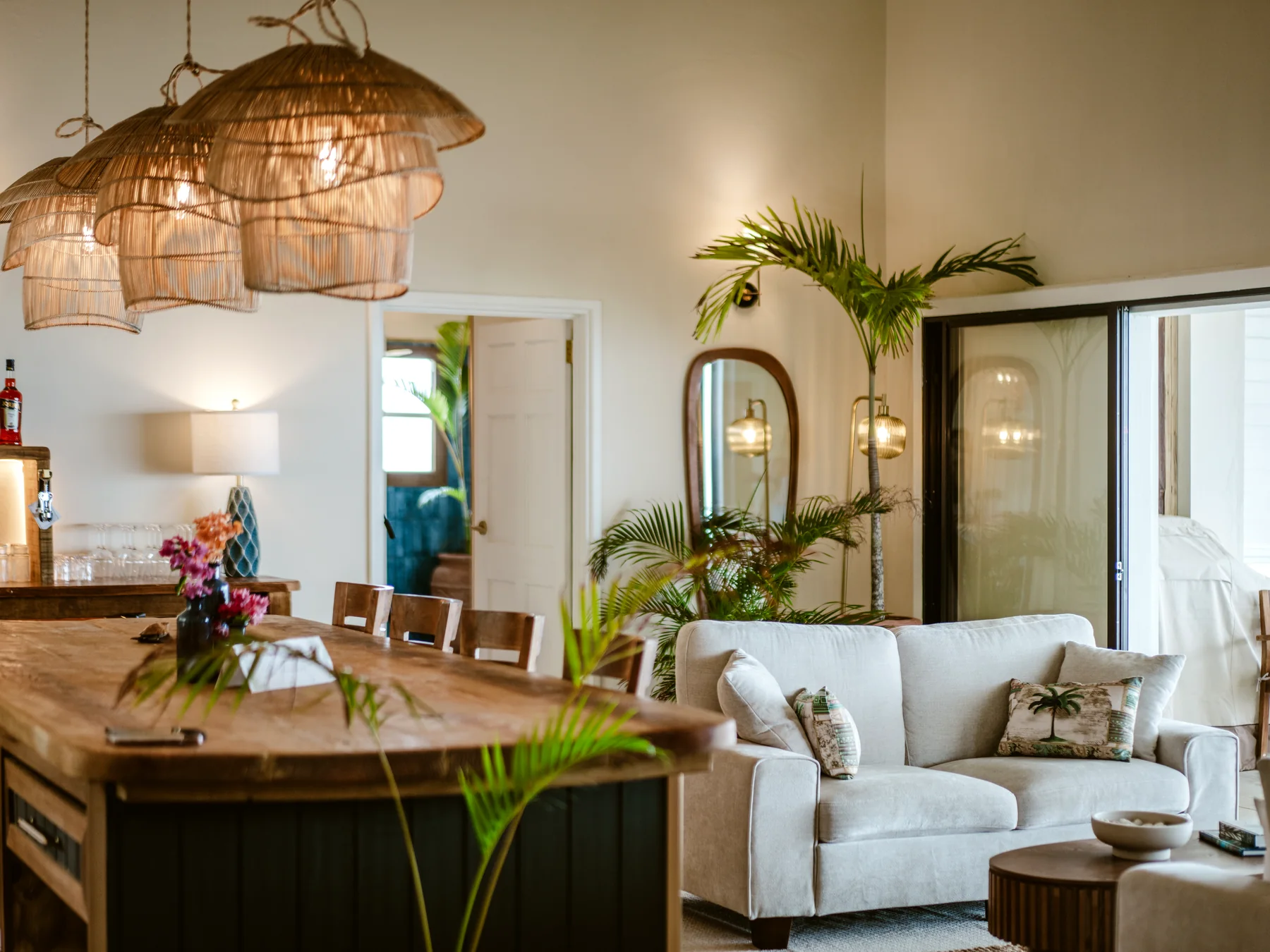 Mer & Sel Villa living room with sofa, plants, and indoor-outdoor light