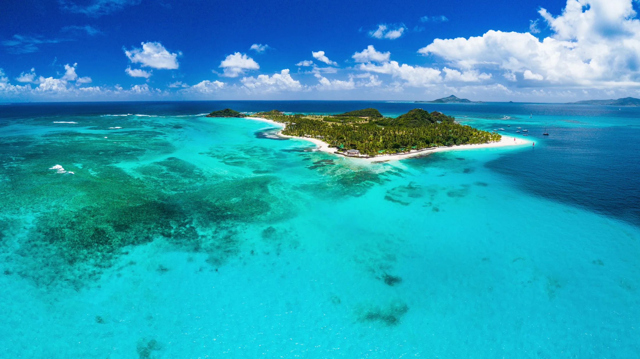 Aerial view of Palm Island with turquoise water near Union Island